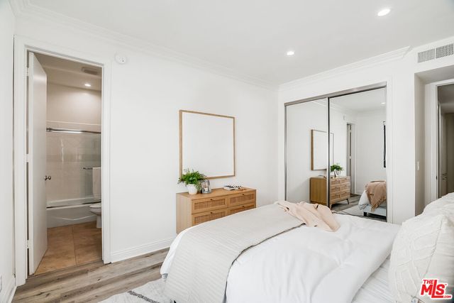 a bedroom with a bed and a mirror