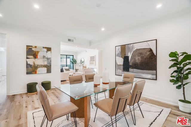 a living room with furniture and a painting on the wall