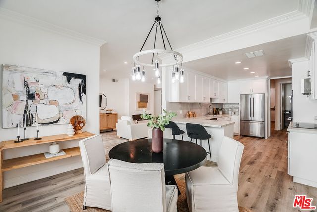 a kitchen with stainless steel appliances kitchen island granite countertop a sink a stove and cabinets