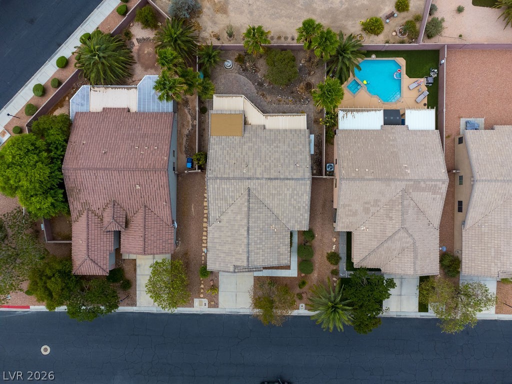 3591 Driving Range Street Las Vegas, NV 89122 - Photo 11 of 79 An aerial view captures the rooftops and private yards of several residences, showcasing a refreshing pool.