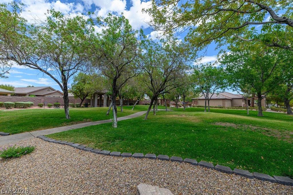 3591 Driving Range Street Las Vegas, NV 89122 - Photo 16 of 79 Lush green spaces and mature trees offer a serene setting for community living.