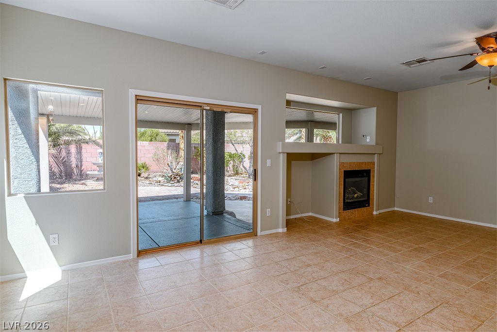 3591 Driving Range Street Las Vegas, NV 89122 - Photo 20 of 79 This bright living area features outdoor access and a modern fireplace.