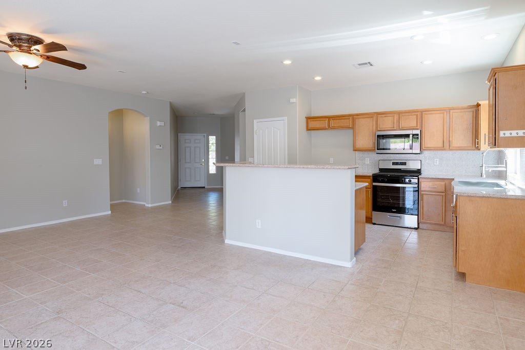 3591 Driving Range Street Las Vegas, NV 89122 - Photo 21 of 79 This open concept space features a well-appointed kitchen and inviting living area, perfect for daily living.
