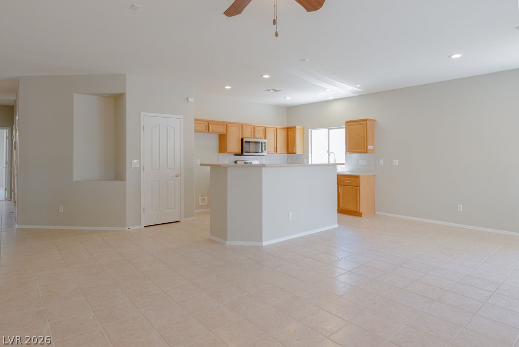 3591 Driving Range Street Las Vegas, NV 89122 - Photo 22 of 79 This bright, open-concept living space integrates a functional kitchen with a welcoming atmosphere.