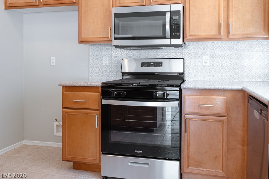 3591 Driving Range Street Las Vegas, NV 89122 - Photo 24 of 79 This functional kitchen features stainless steel appliances, ample cabinetry, and tile flooring.