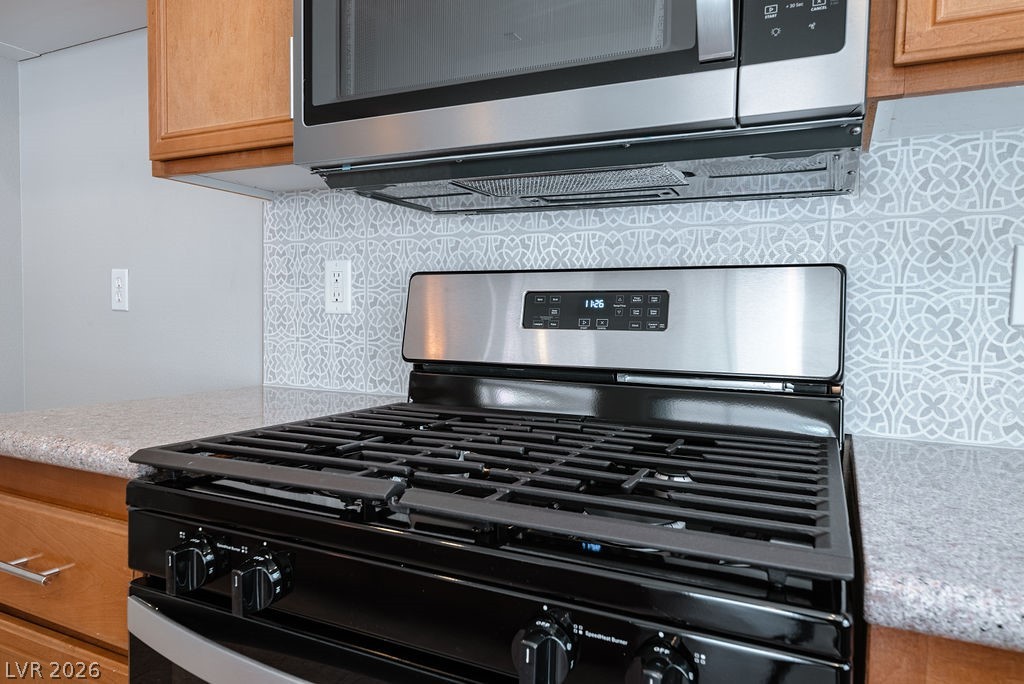 3591 Driving Range Street Las Vegas, NV 89122 - Photo 25 of 79 This modern kitchen features stylish countertops and state-of-the-art appliances, perfect for culinary adventures.