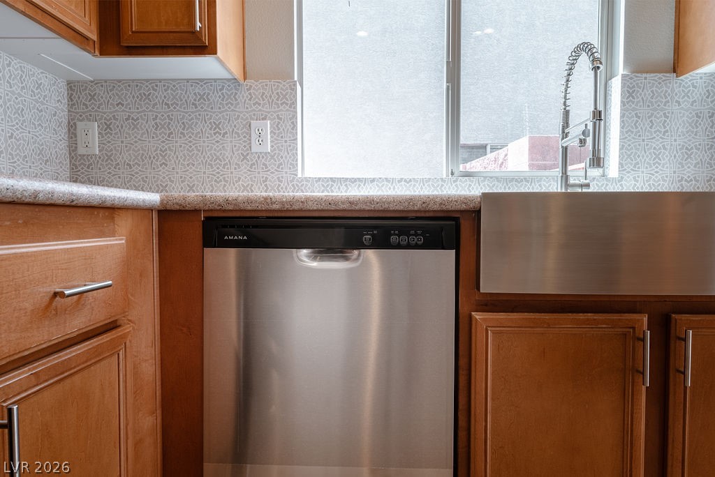 3591 Driving Range Street Las Vegas, NV 89122 - Photo 27 of 79 This bright kitchen features a stainless steel dishwasher and a contemporary farmhouse sink, perfect for daily living.