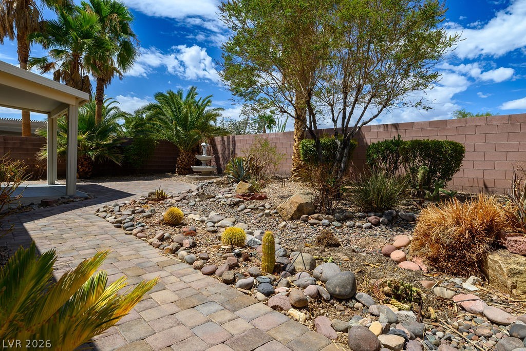 3591 Driving Range Street Las Vegas, NV 89122 - Photo 30 of 79 This desert landscape features a charming paver patio and a delightful water feature.