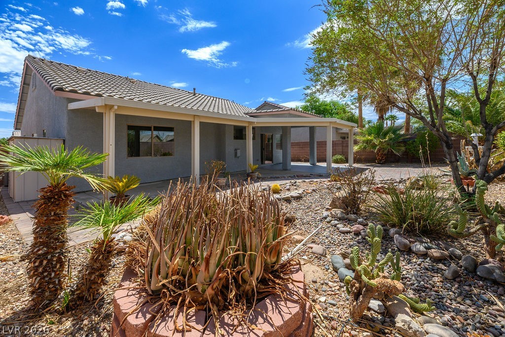 3591 Driving Range Street Las Vegas, NV 89122 - Photo 32 of 79 This desert landscaped backyard offers a covered patio and ample outdoor living space.