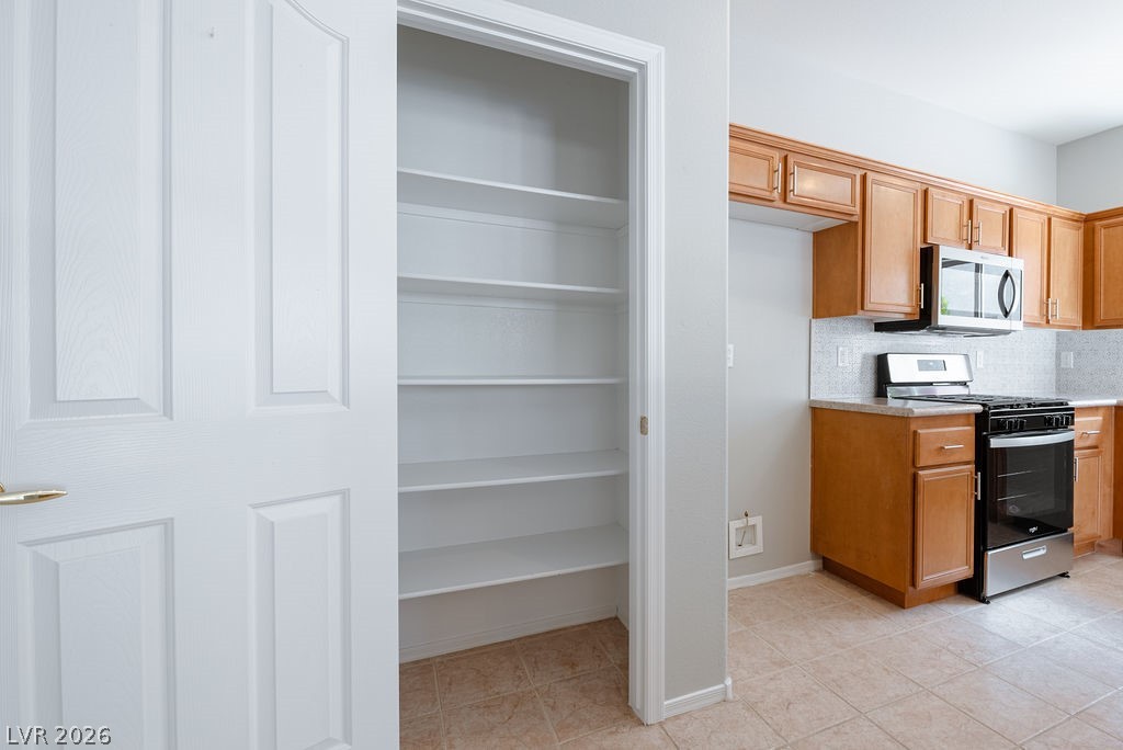 3591 Driving Range Street Las Vegas, NV 89122 - Photo 35 of 79 This thoughtfully designed pantry with ample shelving is adjacent to a well-appointed kitchen.
