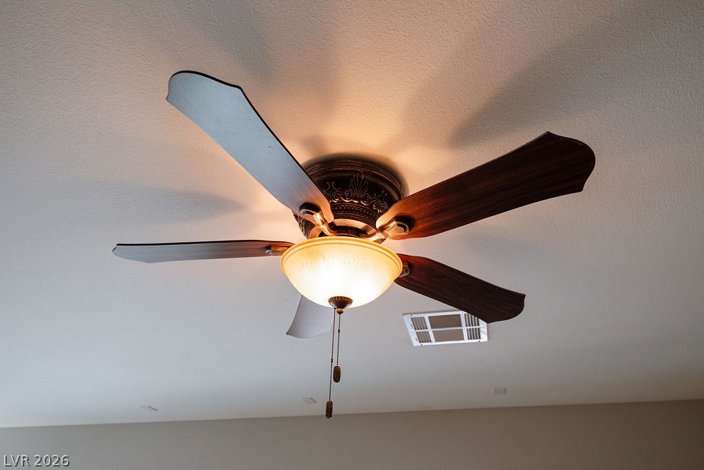 3591 Driving Range Street Las Vegas, NV 89122 - Photo 37 of 79 This living area features a classic ceiling fan, providing both light and comfort.