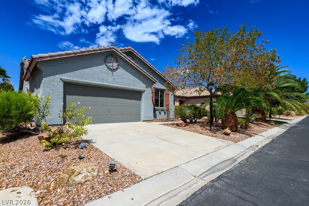 3591 Driving Range Street Las Vegas, NV 89122 - Photo 4 of 79 This charming residence features an attached garage and a well-maintained driveway.