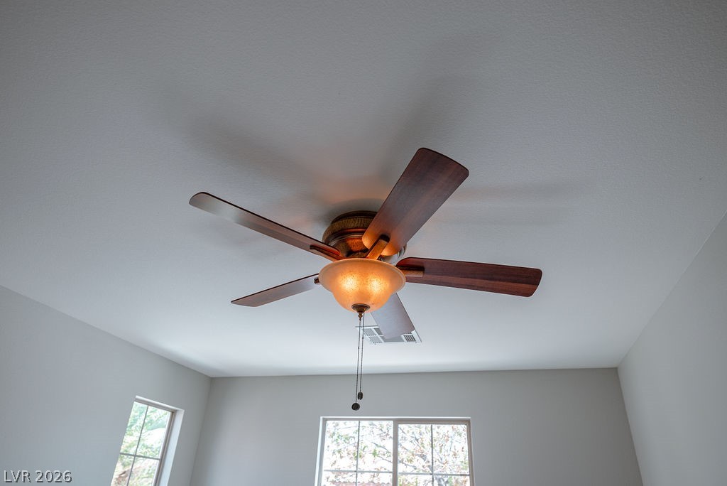 3591 Driving Range Street Las Vegas, NV 89122 - Photo 45 of 79 This bright room features a practical ceiling fan, ensuring comfort and air circulation.