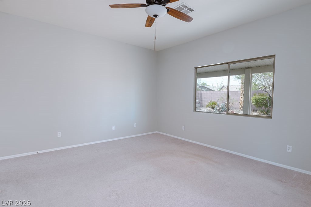 3591 Driving Range Street Las Vegas, NV 89122 - Photo 49 of 79 This airy bedroom features ample natural light and plush carpeting, creating a comfortable and inviting atmosphere.