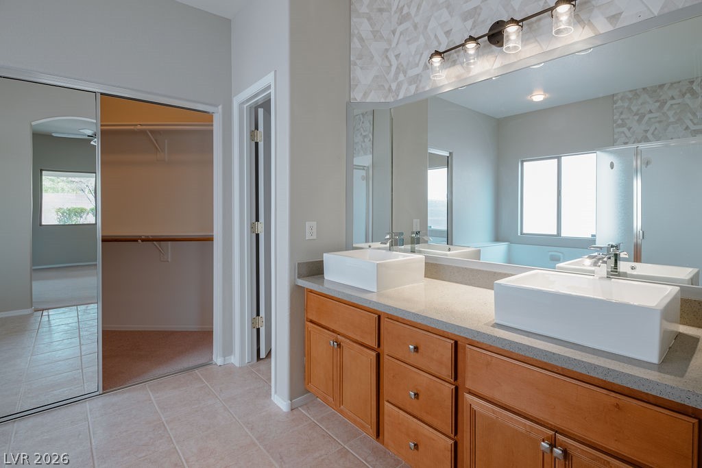 3591 Driving Range Street Las Vegas, NV 89122 - Photo 50 of 79 A well-appointed bathroom features dual vessel sinks and a spacious vanity.