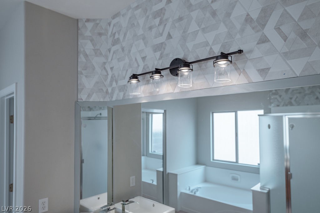 3591 Driving Range Street Las Vegas, NV 89122 - Photo 51 of 79 Reflecting modern elegance, this bathroom features an exquisite vanity and a sleek, geometric tile accent wall.