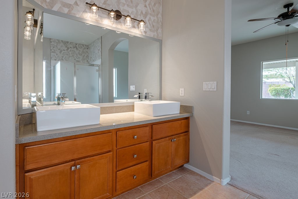 3591 Driving Range Street Las Vegas, NV 89122 - Photo 53 of 79 This bathroom features dual vessel sinks and ample vanity space, perfect for daily routines.