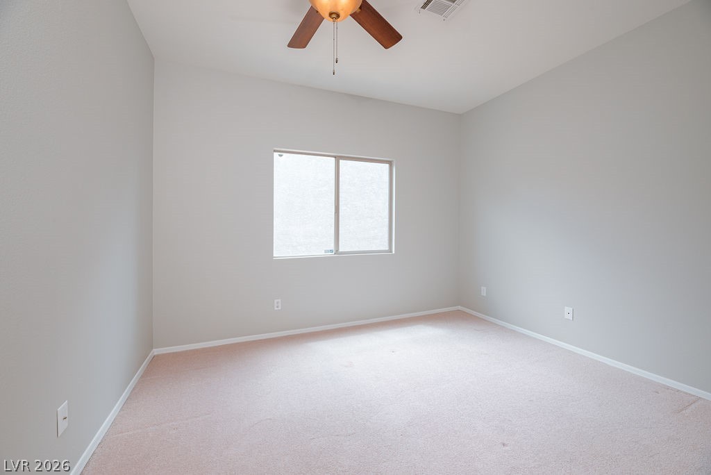 3591 Driving Range Street Las Vegas, NV 89122 - Photo 58 of 79 This airy bedroom offers a serene retreat with soft carpeting and natural light.