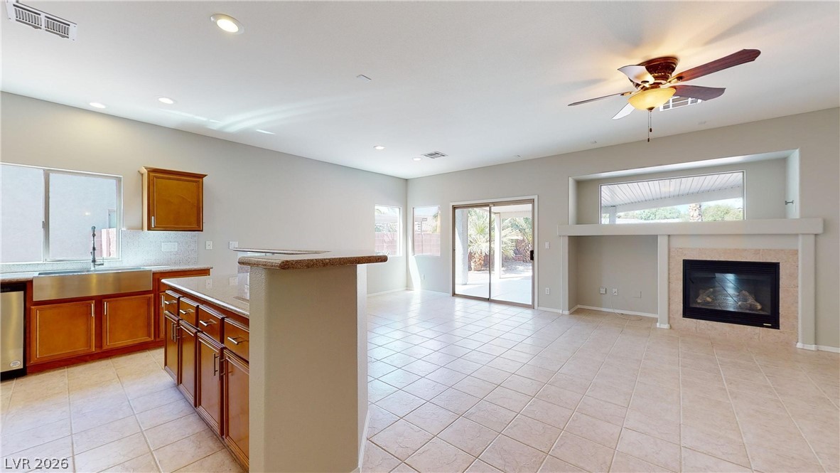 3591 Driving Range Street Las Vegas, NV 89122 - Photo 63 of 79 This bright, open-concept living space features a cozy fireplace and seamless outdoor access.