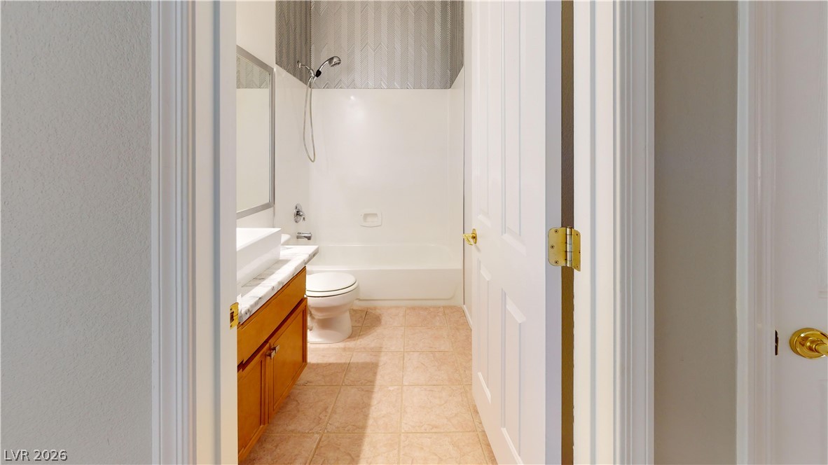 3591 Driving Range Street Las Vegas, NV 89122 - Photo 65 of 79 This bright bathroom features a spacious tub and shower combination with a wide vanity.