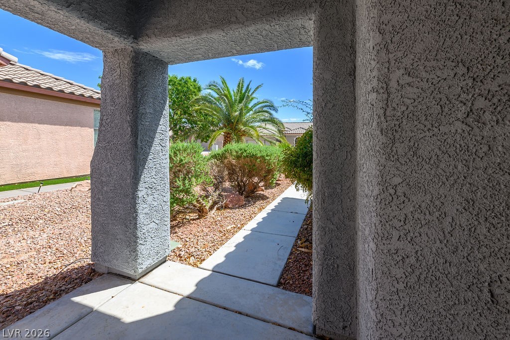 3591 Driving Range Street Las Vegas, NV 89122 - Photo 7 of 79 Welcome to a home featuring a charming entry with lush landscaping and vibrant greenery.