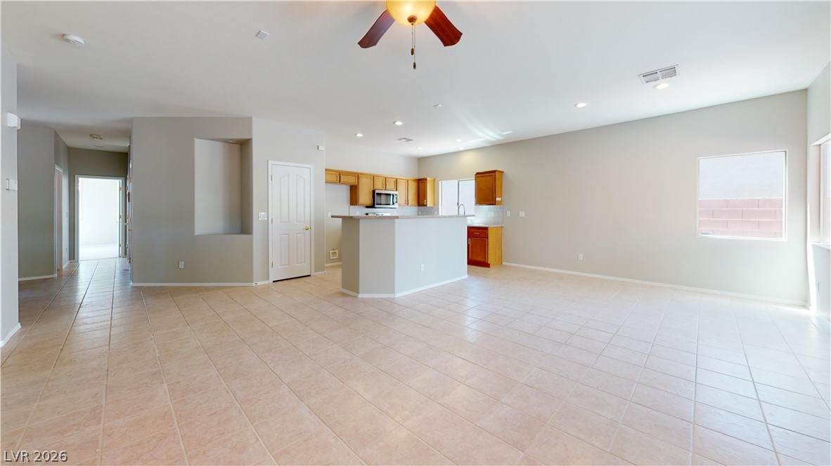 3591 Driving Range Street Las Vegas, NV 89122 - Photo 70 of 79 Bright and open-concept living space features a functional kitchen island and tiled flooring throughout.
