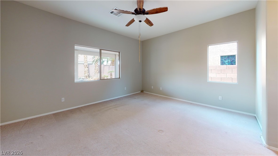 3591 Driving Range Street Las Vegas, NV 89122 - Photo 71 of 79 This spacious bedroom offers ample natural light and a comfortable atmosphere for rest and relaxation.