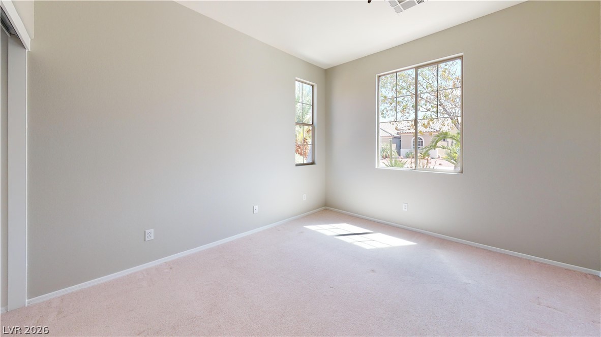 3591 Driving Range Street Las Vegas, NV 89122 - Photo 74 of 79 This spacious bedroom offers ample natural light and a comfortable atmosphere for rest and relaxation.