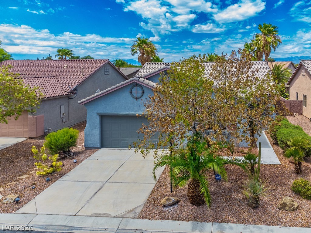 3591 Driving Range Street Las Vegas, NV 89122 - Photo 8 of 79 This charming residence features a spacious driveway and an inviting desert-inspired landscape.