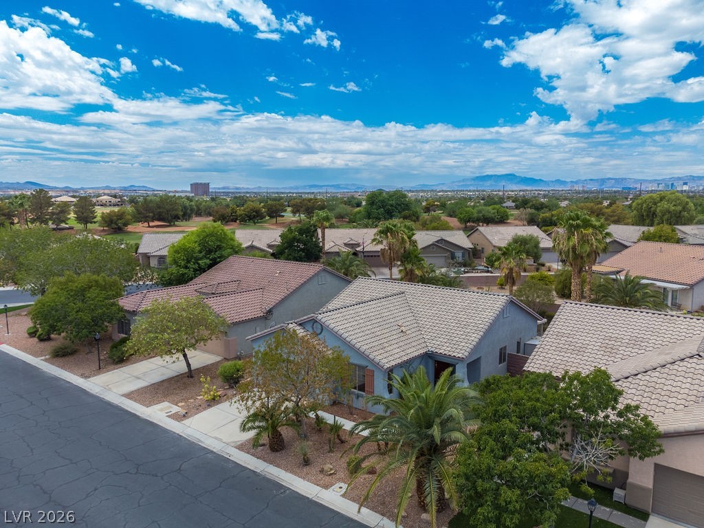 3591 Driving Range Street Las Vegas, NV 89122 - Photo 10 of 79 An aerial perspective reveals a serene suburban neighborhood under a vast sky.