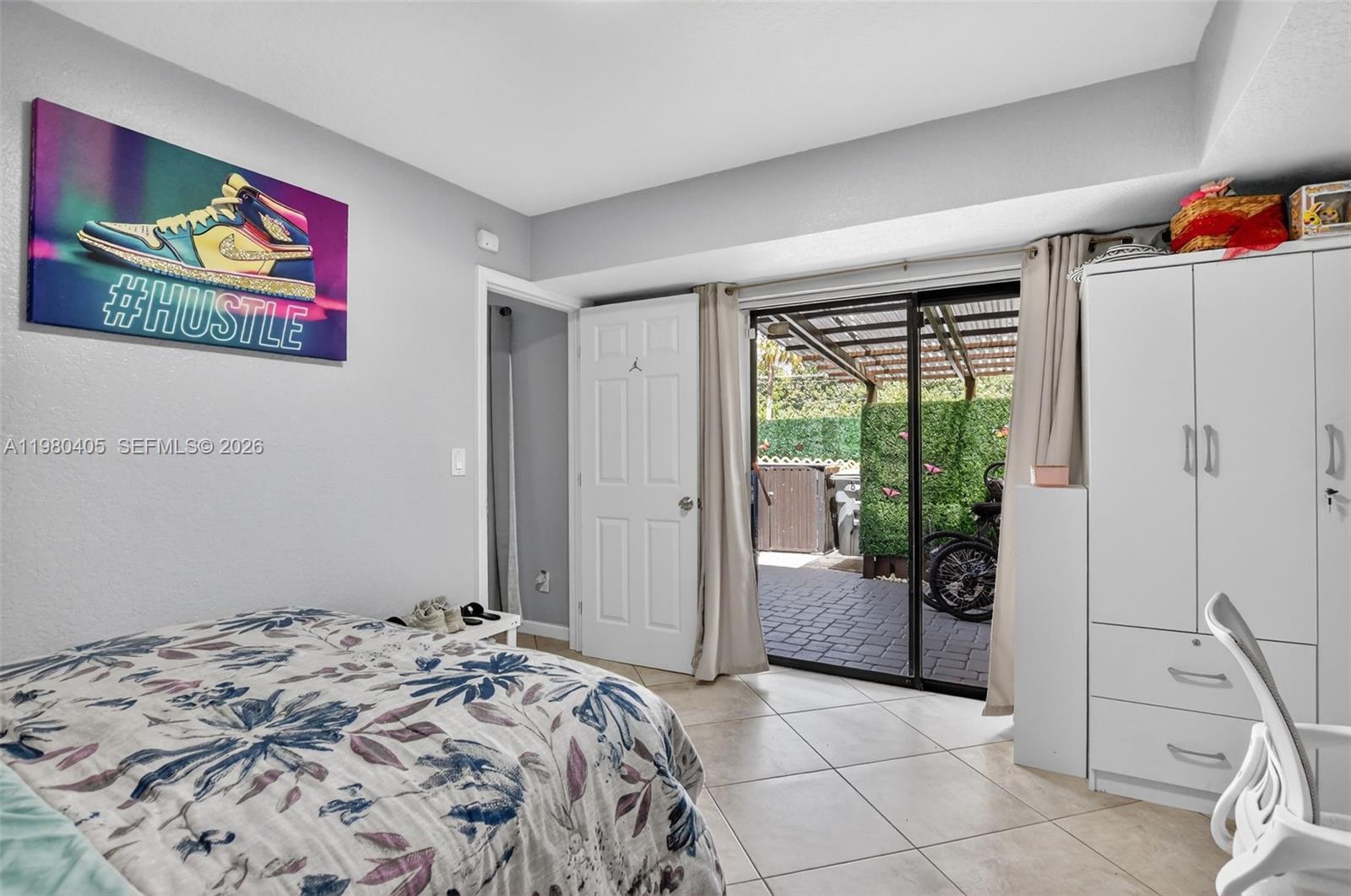 8181 Boca Rio Drive, Unit 8181 Boca Raton, FL 33433 - Photo 11 of 40 a bedroom with a bed and a painting on the wall