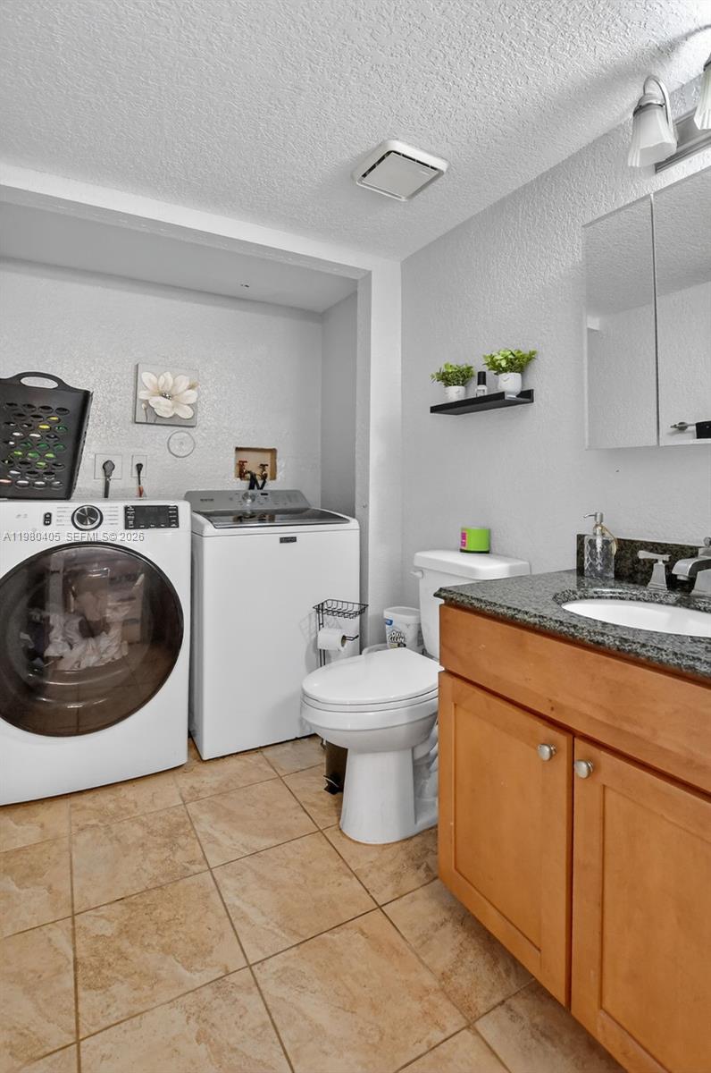 8181 Boca Rio Drive, Unit 8181 Boca Raton, FL 33433 - Photo 13 of 40 a bathroom with a sink mirror vanity and toilet