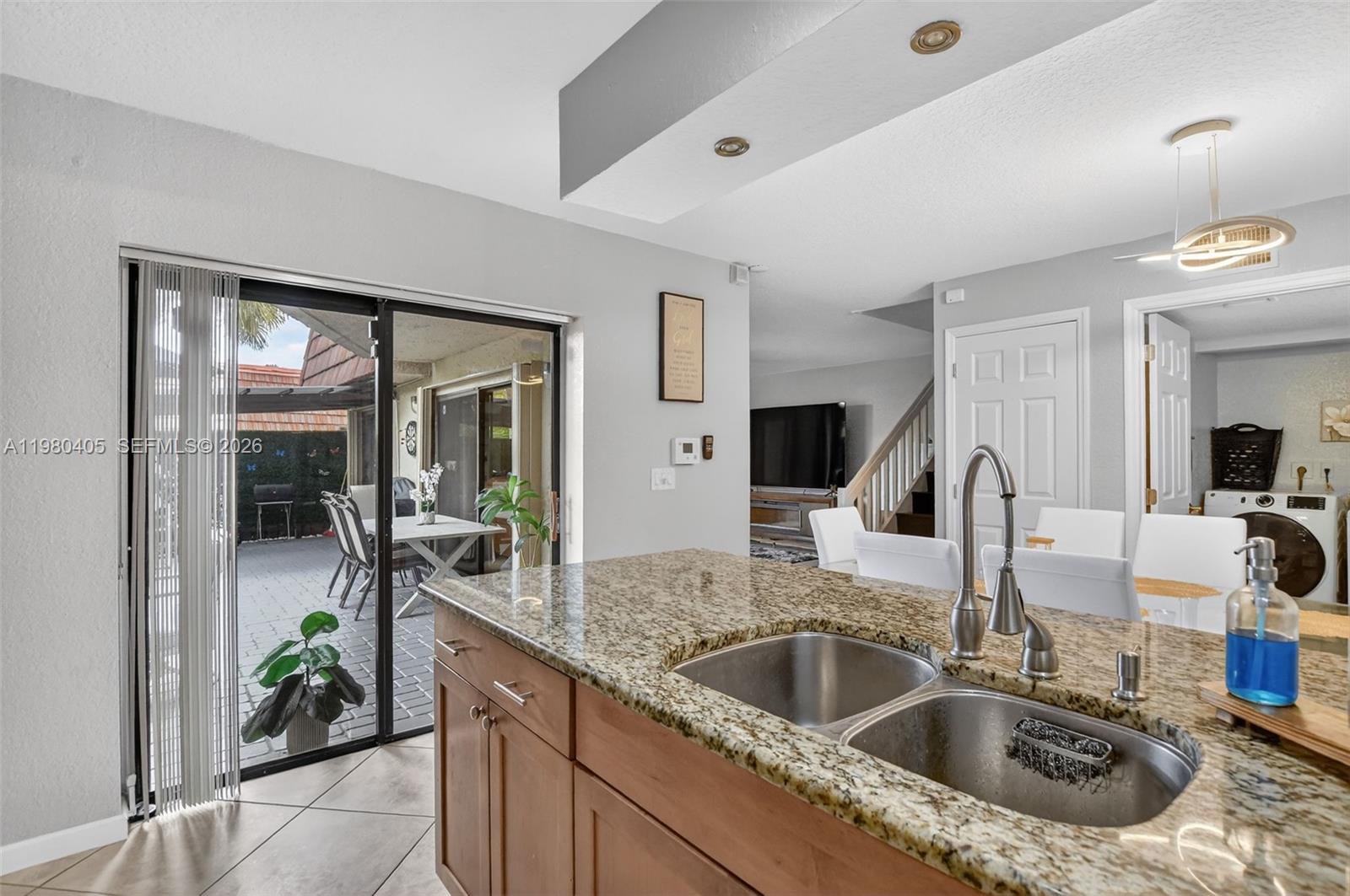 8181 Boca Rio Drive, Unit 8181 Boca Raton, FL 33433 - Photo 15 of 40 a kitchen with a sink and a refrigerator