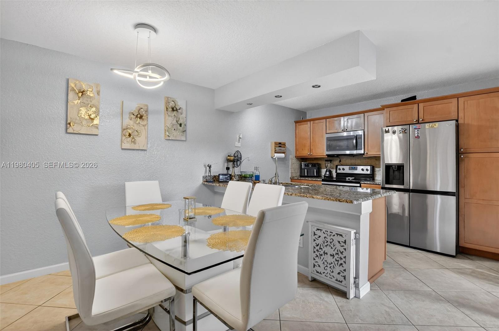 8181 Boca Rio Drive, Unit 8181 Boca Raton, FL 33433 - Photo 18 of 40 a view of kitchen with refrigerator dining table and chairs
