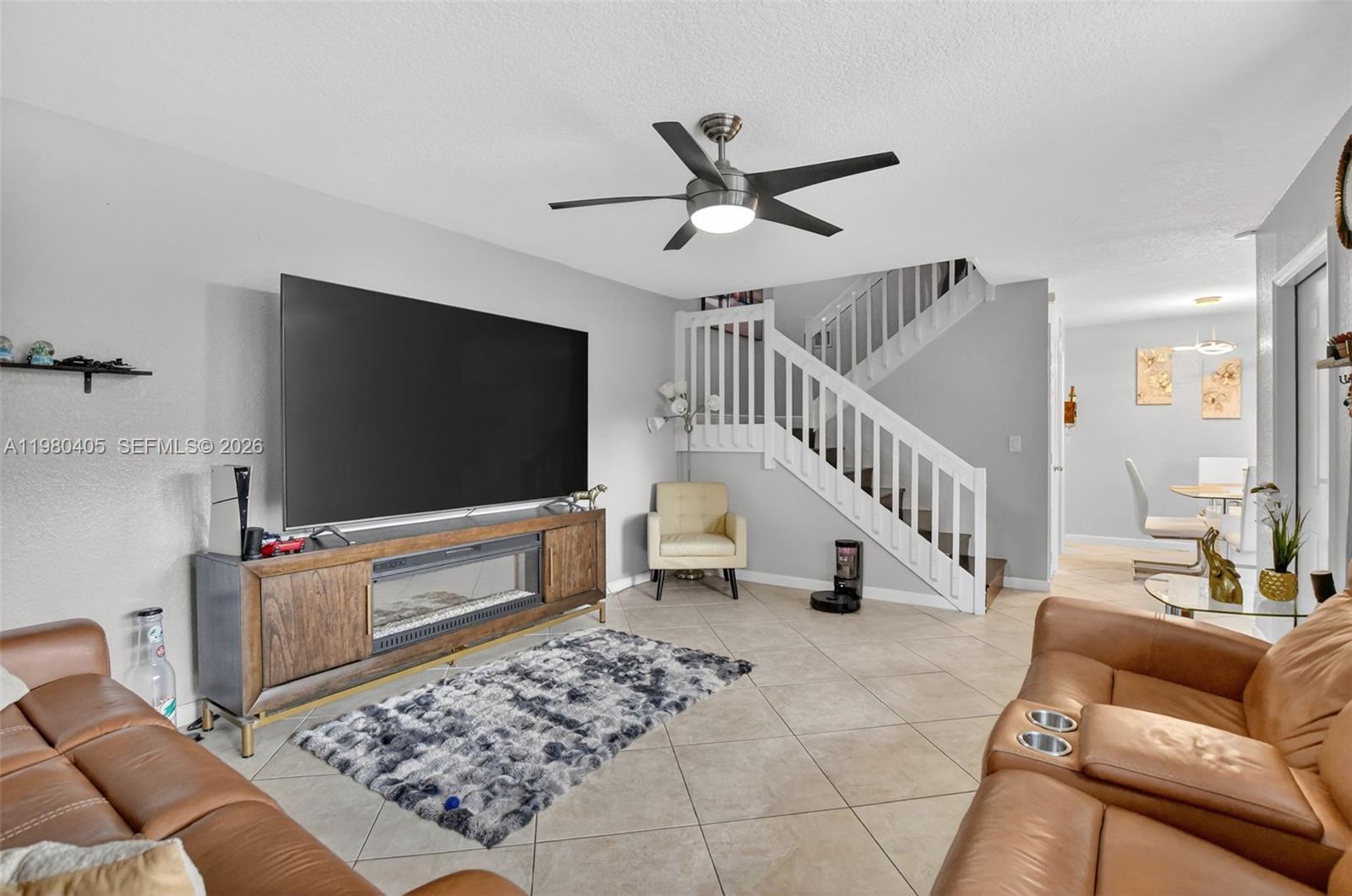 8181 Boca Rio Drive, Unit 8181 Boca Raton, FL 33433 - Photo 21 of 40 a living room with furniture and a flat screen tv