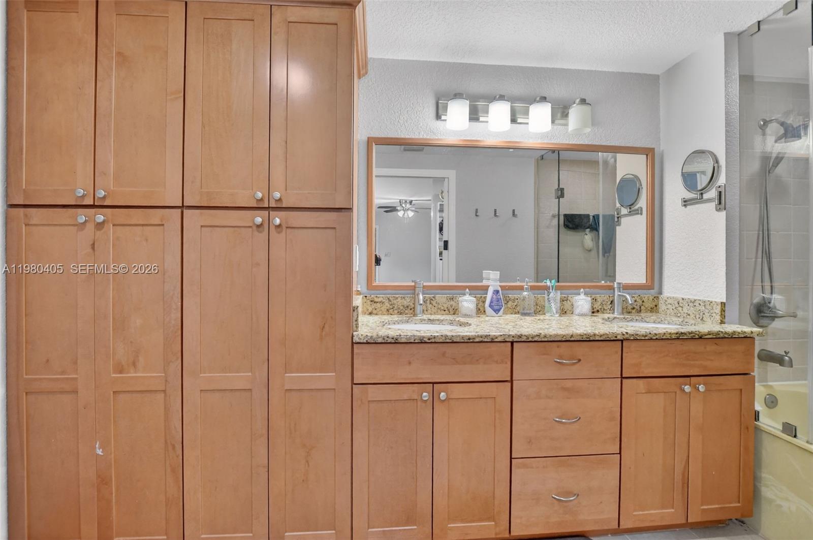 8181 Boca Rio Drive, Unit 8181 Boca Raton, FL 33433 - Photo 25 of 40 a bathroom with a granite countertop sink and a mirror