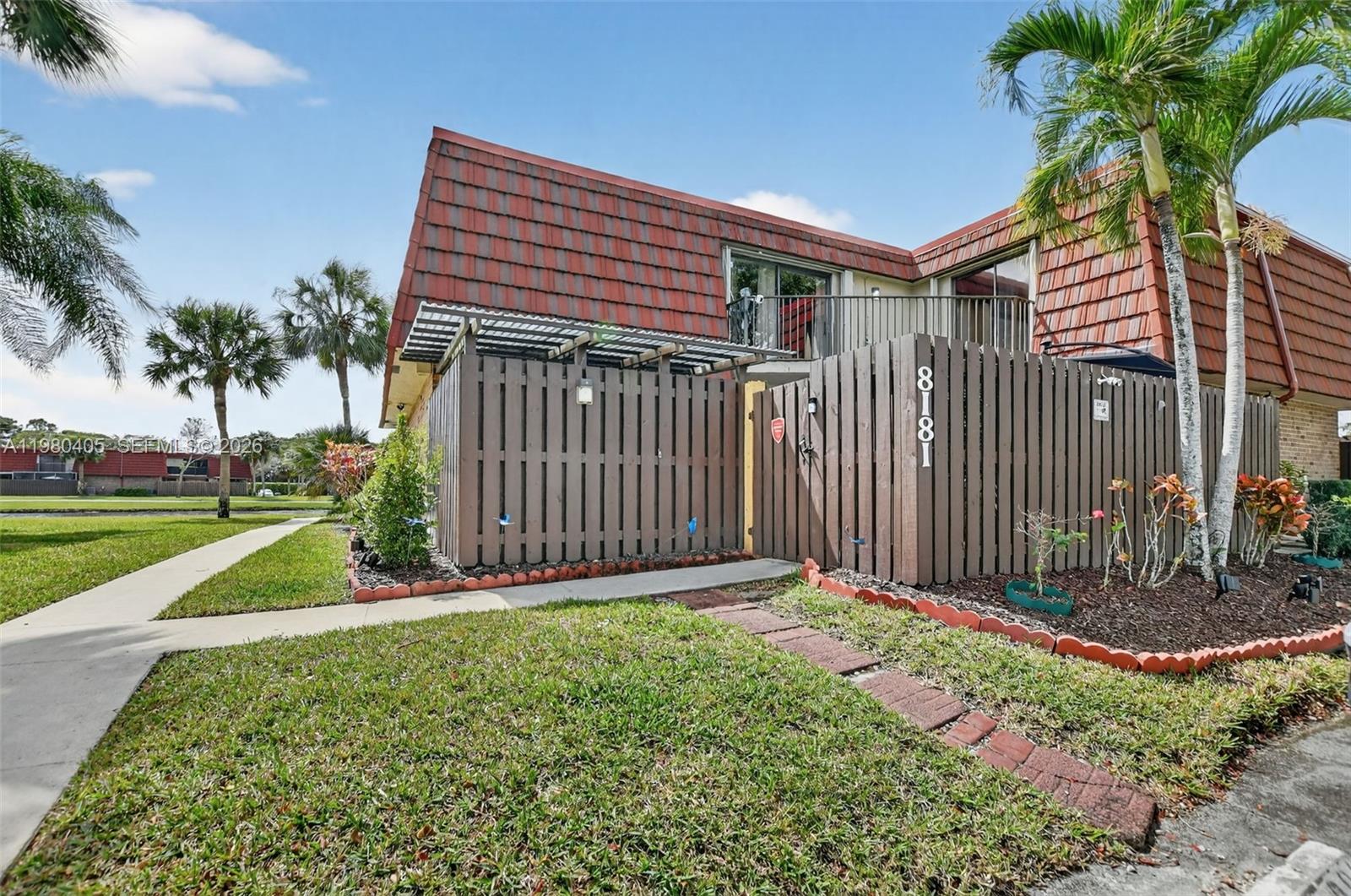 8181 Boca Rio Drive, Unit 8181 Boca Raton, FL 33433 - Photo 37 of 40 a front view of a house with a yard