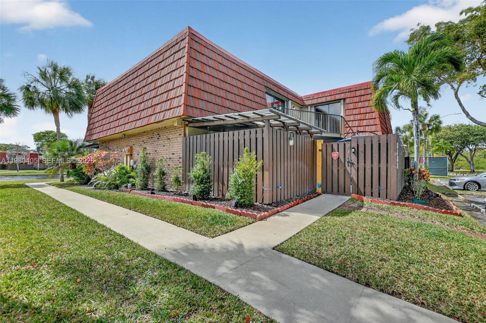8181 Boca Rio Drive, Unit 8181 Boca Raton, FL 33433 - Photo 38 of 40 a view of a house with a yard and potted plants