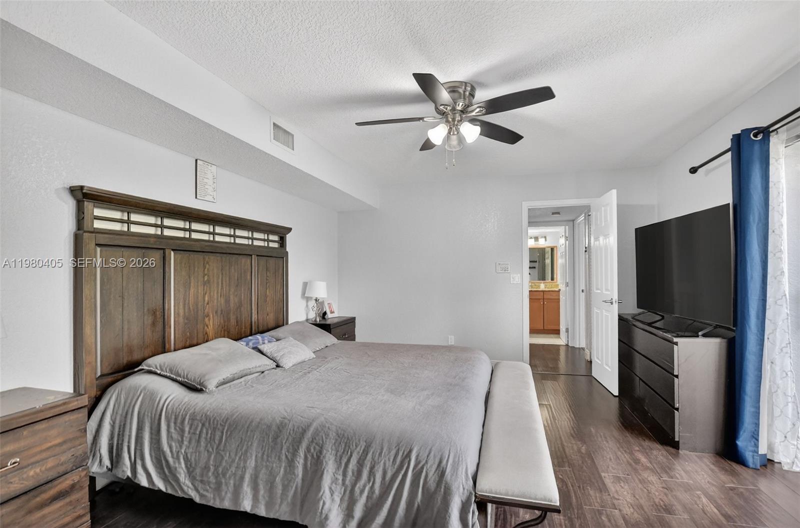 8181 Boca Rio Drive, Unit 8181 Boca Raton, FL 33433 - Photo 7 of 40 a bedroom with a bed and a flat screen tv