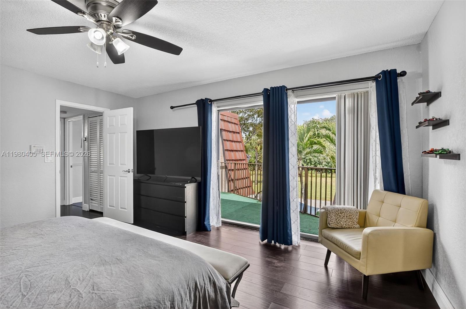 8181 Boca Rio Drive, Unit 8181 Boca Raton, FL 33433 - Photo 8 of 40 a bedroom with a bed and a chandelier