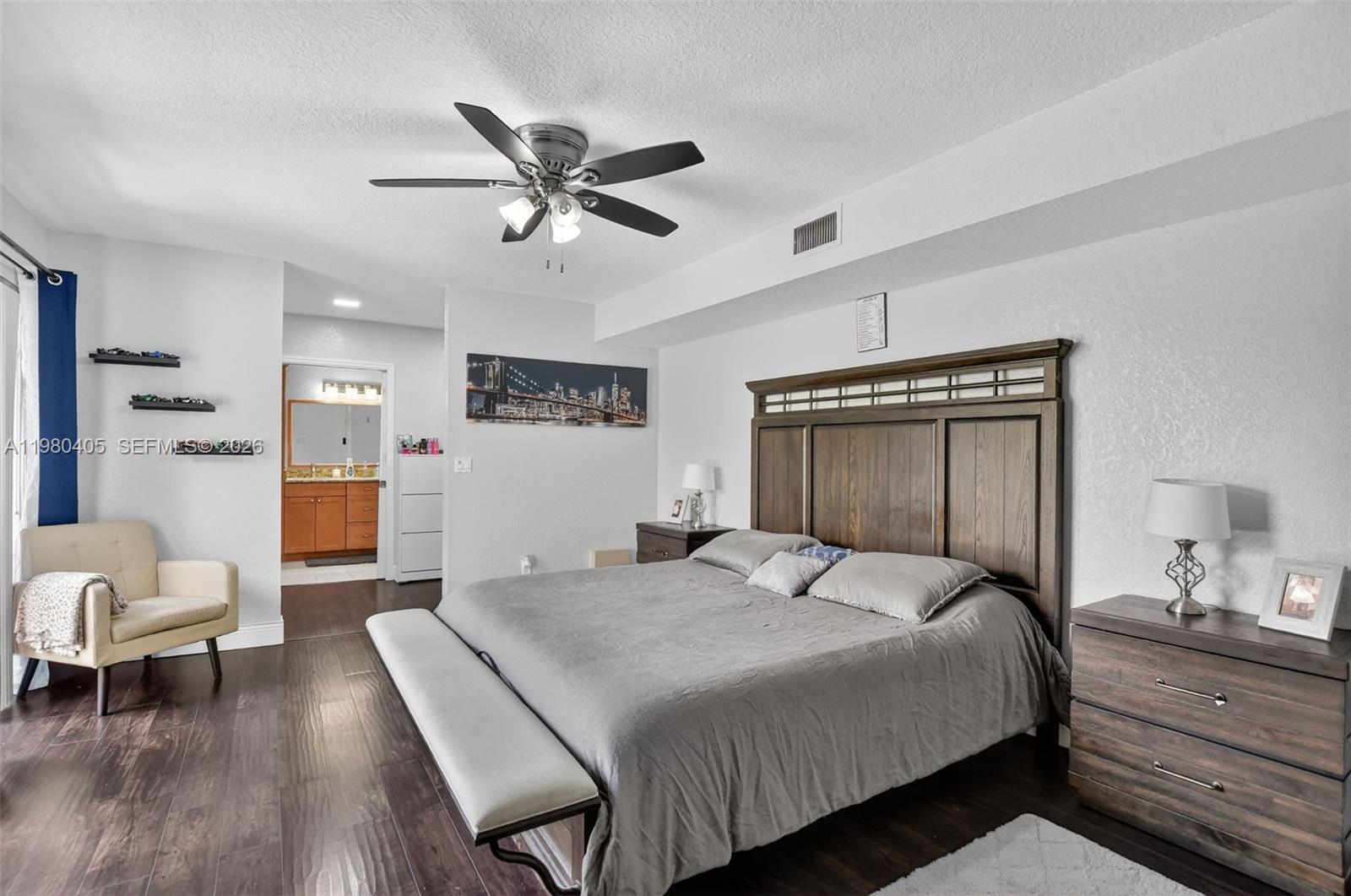 8181 Boca Rio Drive, Unit 8181 Boca Raton, FL 33433 - Photo 9 of 40 a bedroom with a bed and wooden floor