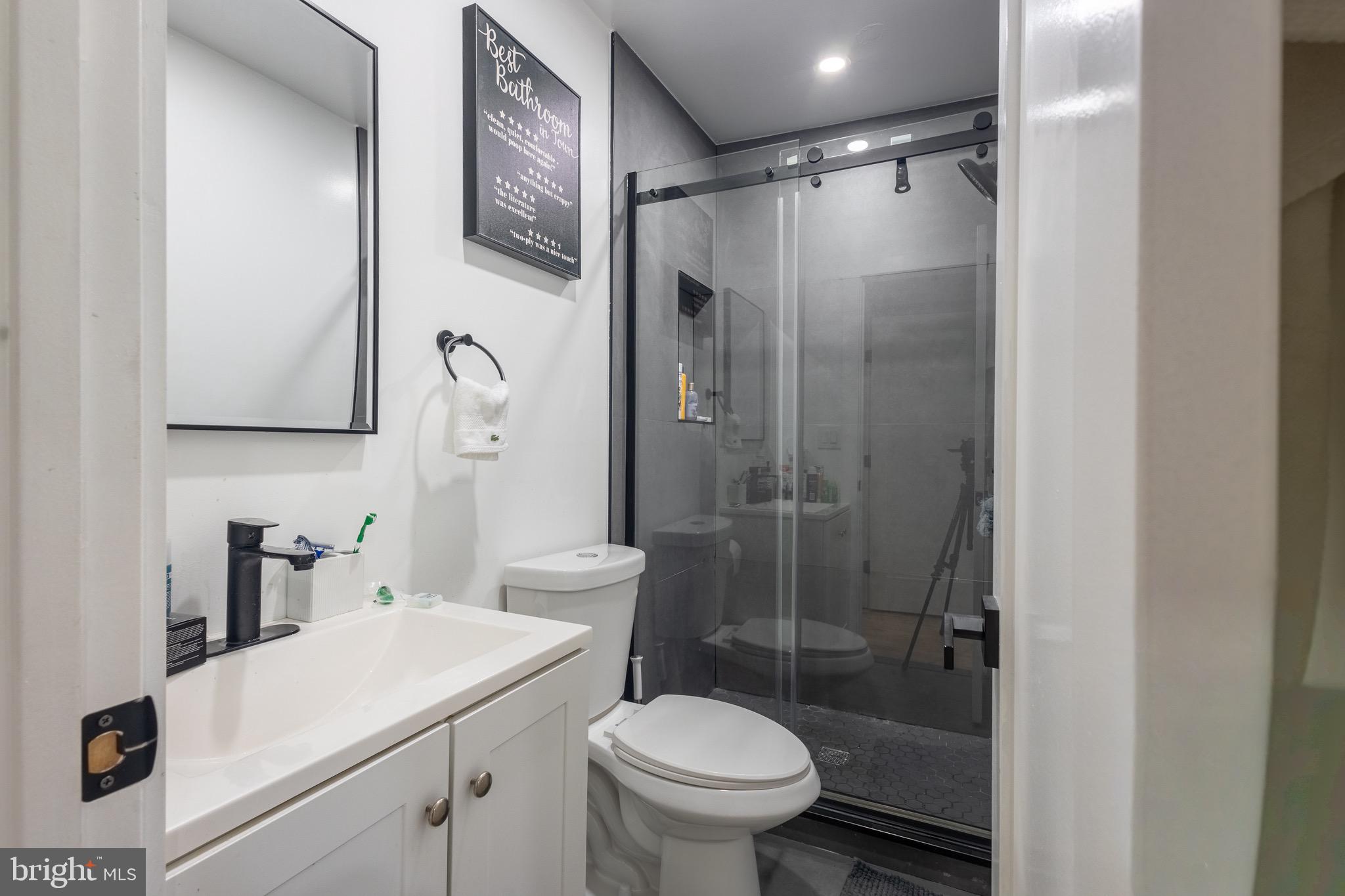 37 4th Street Laurel, MD 20707 - Photo 18 of 26 a bathroom with a sink toilet and shower