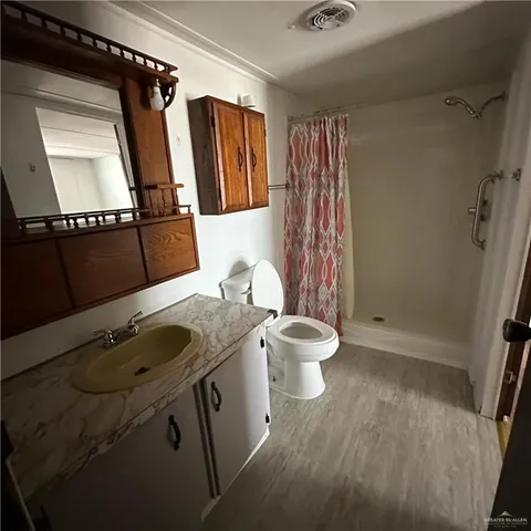 a bathroom with a sink toilet and shower
