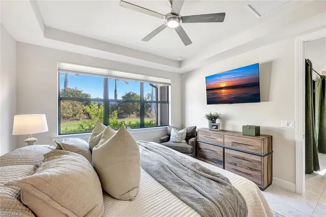 a bedroom with a bed and glass window