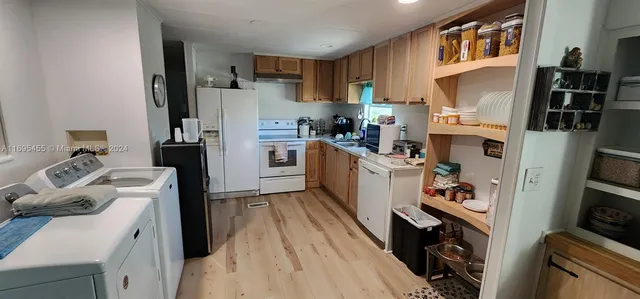 a view of a kitchen with a sink and a window