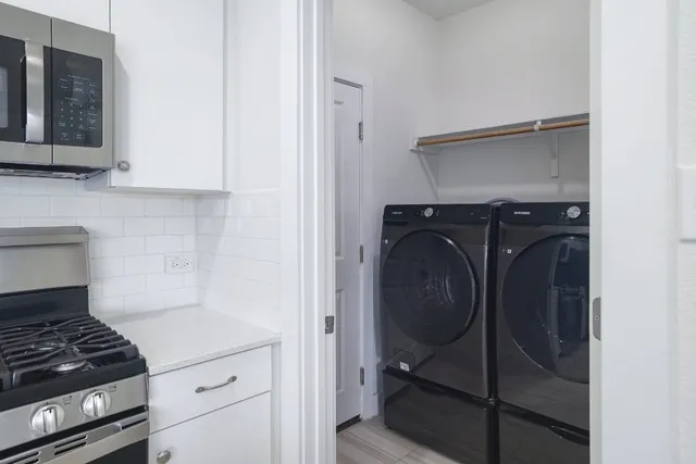 a view of a kitchen with dining table and chairs