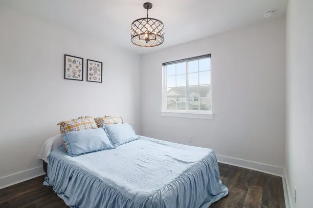 a bedroom with two beds and a window