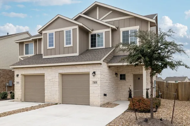 a front view of a house with a garage