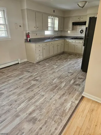 a kitchen with stainless steel appliances cabinets a sink and a stove