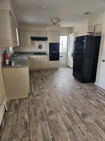 a kitchen with a refrigerator and a stove